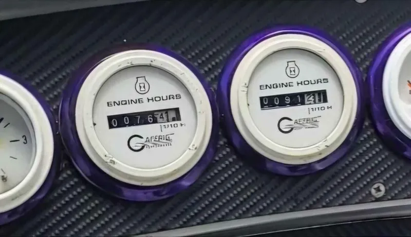 Slide: The Image of Close-up of Wellcraft SCARAB 1996 engine hour meters on carbon fiber panel. - 17