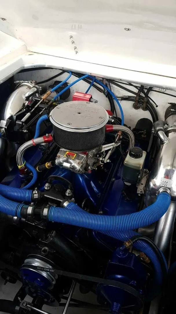 Slide: The Image of Engine of a 1996 Wellcraft SCARAB with blue hoses and chrome components. - 18