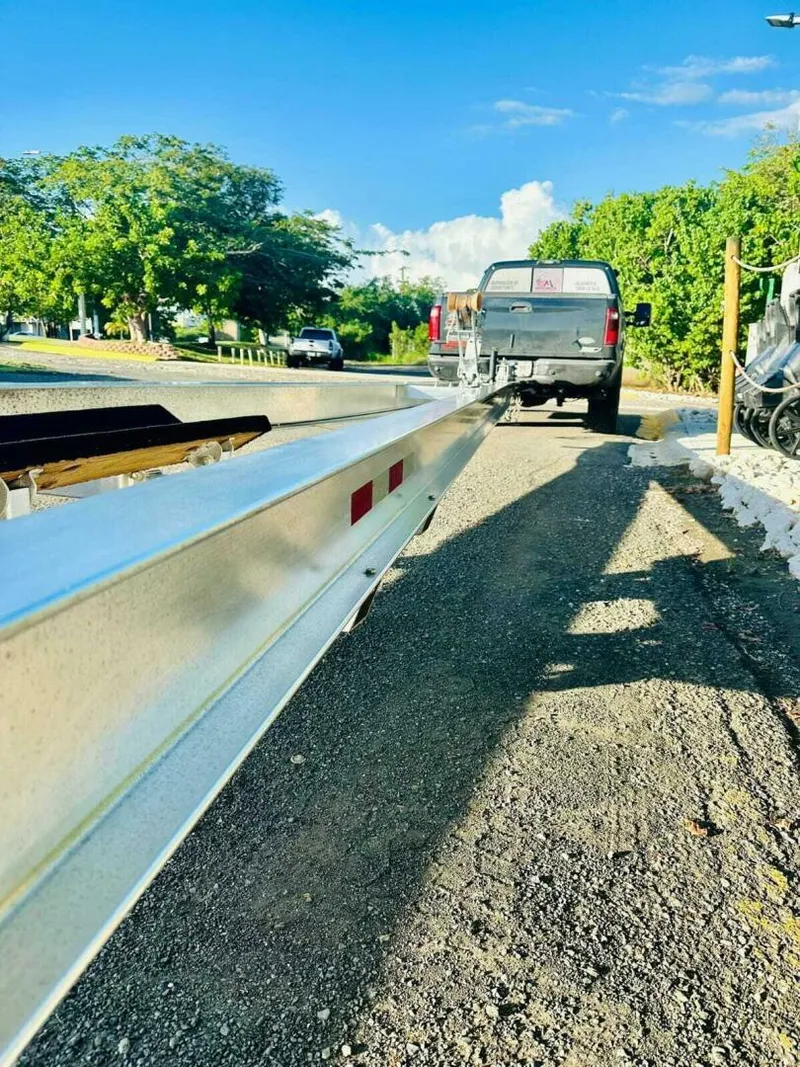 Slide: The Image of Truck towing a 1996 Wellcraft SCARAB boat trailer on a sunny road. - 24
