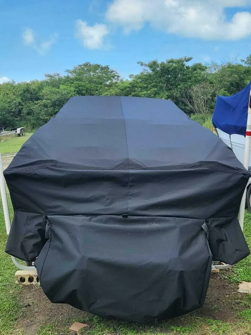 Slide: The Image of Covered 1996 Wellcraft SCARAB boat on grass, under a clear blue sky. - 26