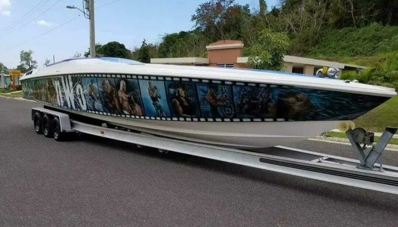 Slide: The Image of 1996 Wellcraft SCARAB boat with vibrant graphics on a trailer. - 3