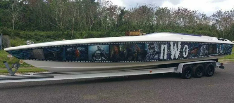 Slide: The Image of 1996 Wellcraft SCARAB boat with custom graphics and "nWo" text on trailer. - 4