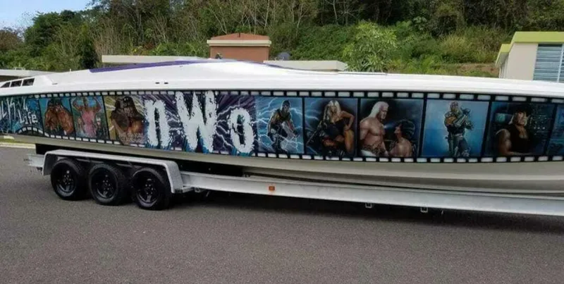 Slide: The Image of 1996 Wellcraft SCARAB boat with NWO-themed graphics on a trailer. - 5