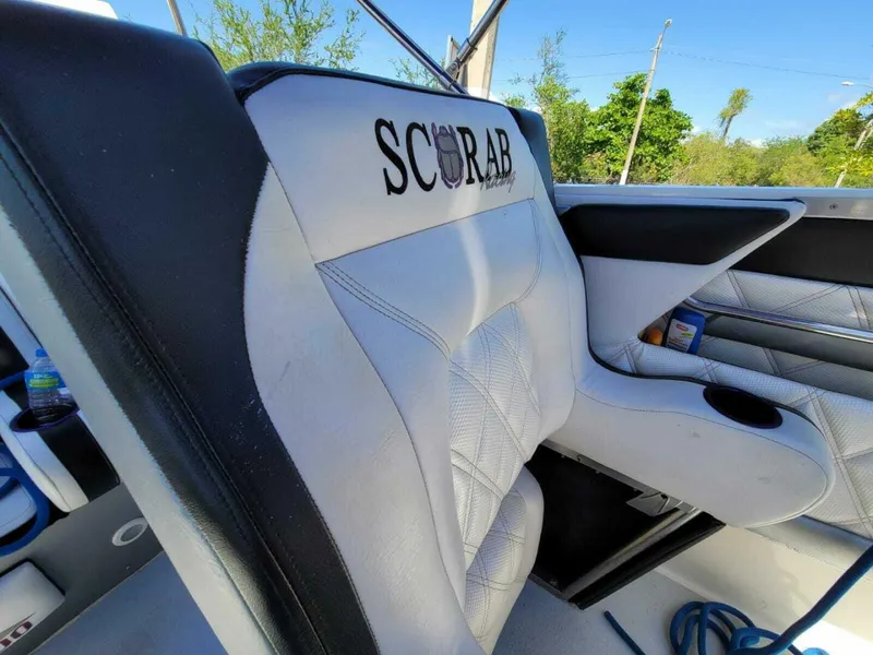 Slide: The Image of 1996 Wellcraft SCARAB boat interior with white and black seating. - 9
