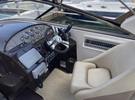 Slide: The Image of 2013 Regal 30 Express boat cockpit with steering wheel and control panel. - 11