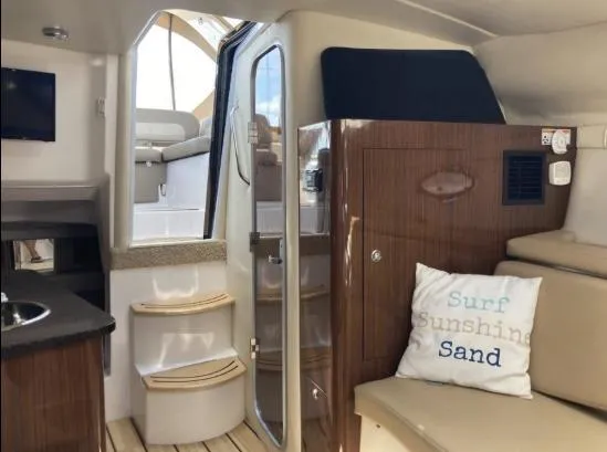 Slide: The Image of Interior of 2013 Regal 30 Express boat with cozy seating and nautical decor. - 19