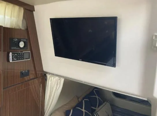 Slide: The Image of Interior of 2013 Regal 30 Express boat with TV and cozy seating area. - 21