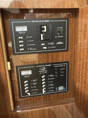 Slide: The Image of Electrical panel on a 2013 Regal 30 Express boat, featuring AC and DC controls. - 26