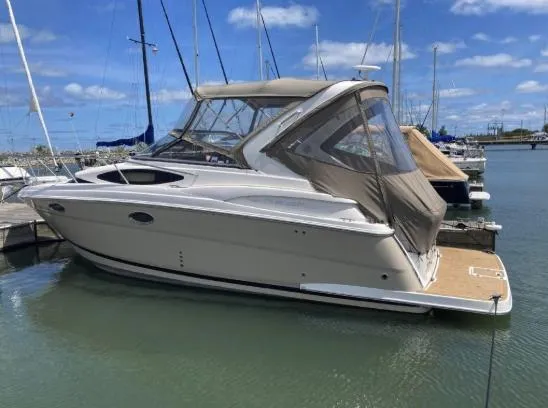 Slide: The Image of 2013 Regal 30 Express boat docked in marina under blue sky. - 3
