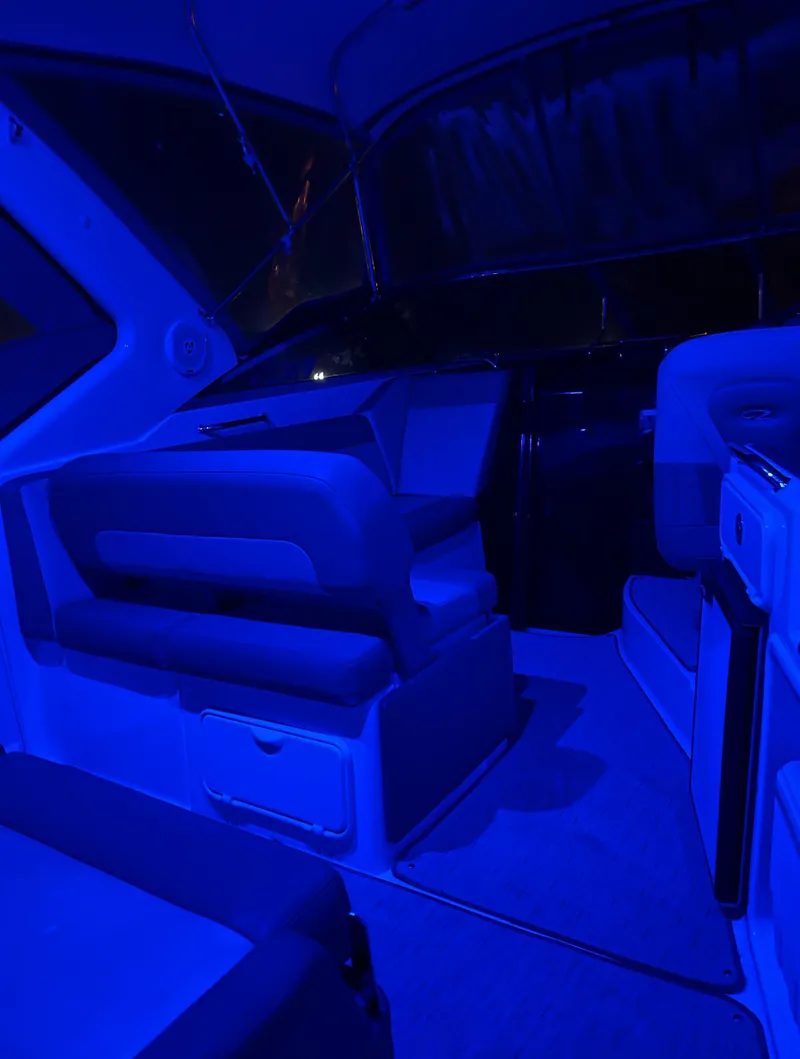 Slide: The Image of Interior of a 2013 Regal 30 Express boat illuminated in blue lighting. - 30
