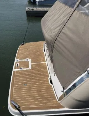 Slide: The Image of 2013 Regal 30 Express boat with teak deck at marina. - 6