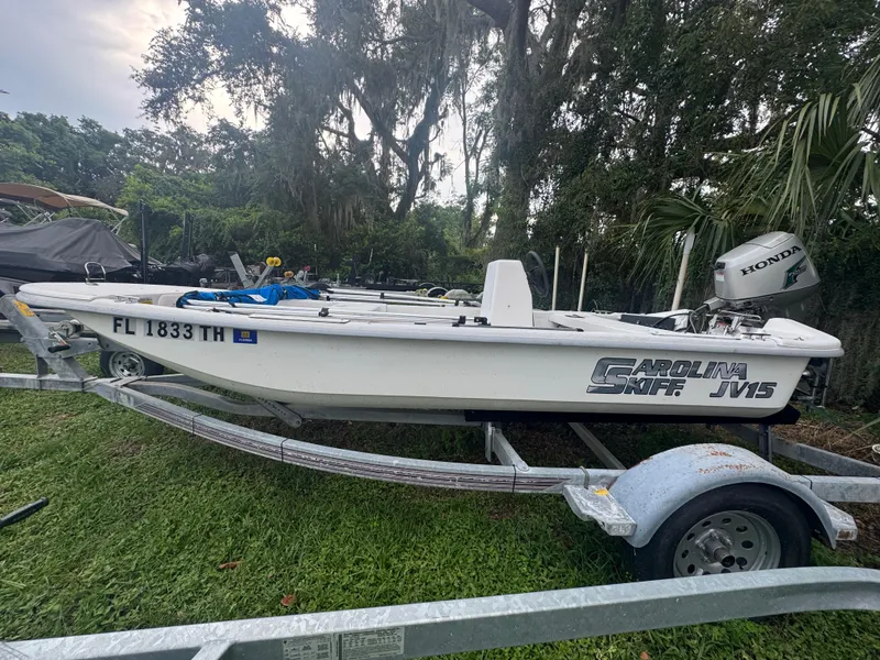 Slide: The Image of 2009 Carolina Skiff JV15CC boat on trailer with Honda outboard motor. - 1