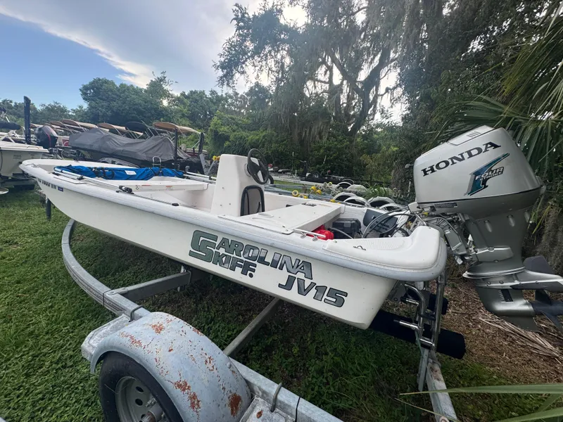 Slide: The Image of 2009 Carolina Skiff JV15CC boat with Honda outboard motor on a trailer. - 3