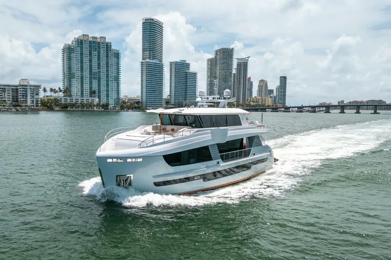 The Image of Luxurious 2020 Hargrave C92 yacht cruising near city skyline on a sunny day. - 0
