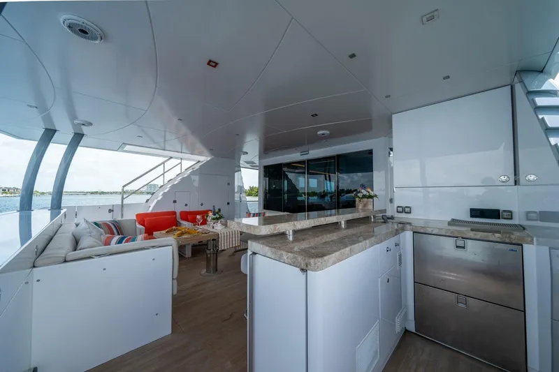 Slide: The Image of Luxurious 2020 Hargrave C92 yacht interior with modern kitchen and comfortable seating area. - 11