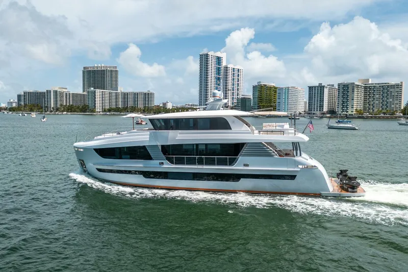 Slide: The Image of Luxurious 2020 Hargrave C92 yacht cruising near city skyline on a sunny day. - 2