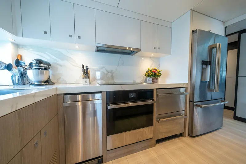 Slide: The Image of Modern kitchen in 2020 Hargrave C92 yacht with stainless steel appliances and marble countertops. - 21