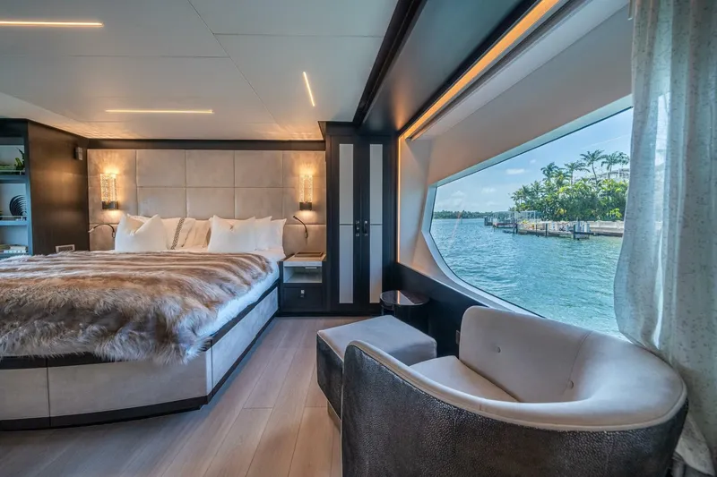 Slide: The Image of Luxurious 2020 Hargrave C92 yacht bedroom with waterfront view, elegant decor, and plush bedding. - 26