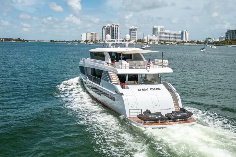 Slide: The Image of Luxury Hargrave C92 yacht cruising in sunny waters, 2020 model, with city skyline in background. - 3