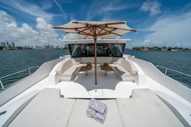 Slide: The Image of Luxurious 2020 Hargrave C92 yacht deck with seating, umbrella, and ocean view. - 49