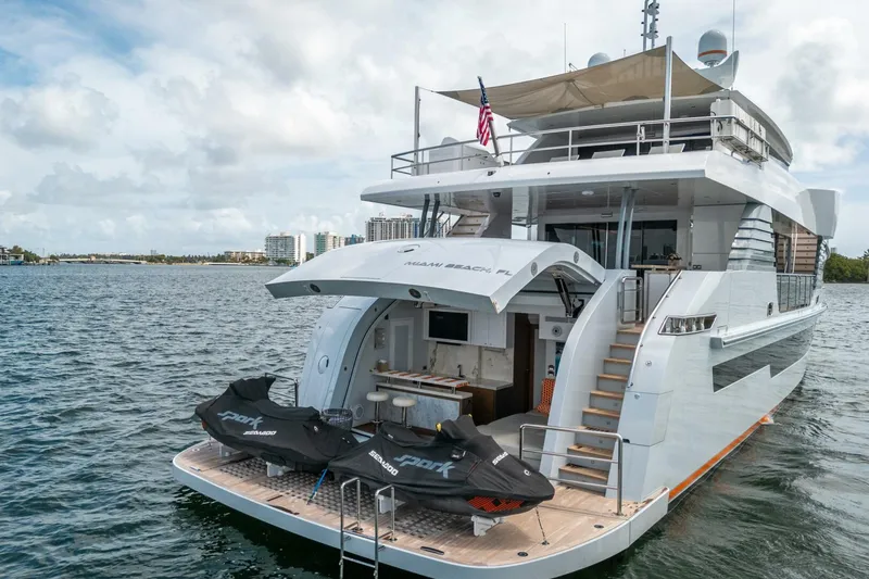 Slide: The Image of Luxury Hargrave C92 yacht, 2020 model, docked with jet skis on deck. - 5