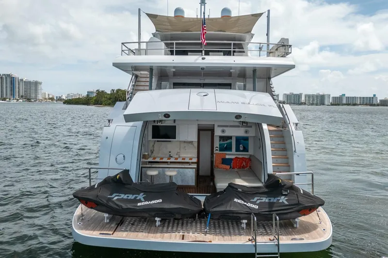 Slide: The Image of Luxury Hargrave C92 yacht with jet skis, docked in scenic waters, 2020 model. - 6