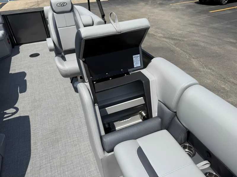 Slide: The Image of 2026 Bentley Pontoons Legacy 200 Navigator interior with open storage compartment and gray seating. - 13