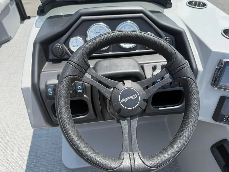 Slide: The Image of Steering wheel of 2026 Bentley Pontoons Legacy 200 Navigator with dashboard controls. - 18