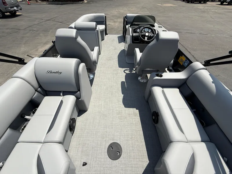 Slide: The Image of 2026 Bentley Pontoons Legacy 200 Navigator interior with luxurious seating and modern dashboard. - 24