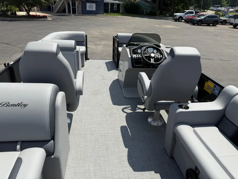 Slide: The Image of 2026 Bentley Pontoons Legacy 200 Navigator interior with gray seating and steering console. - 25
