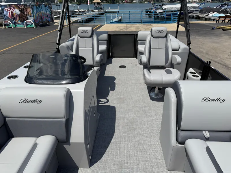 Slide: The Image of 2026 Bentley Pontoons Legacy 200 Navigator interior with luxurious seating and sleek design. - 9