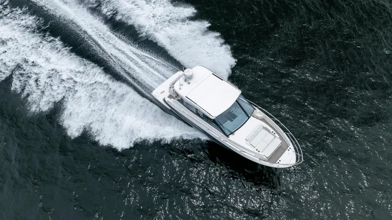 Slide: The Image of 2022 Regal 36 Grande Coupe cruising on open water, aerial view. - 10