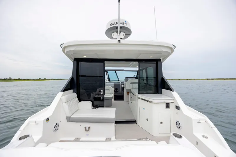 Slide: The Image of 2022 Regal 36 Grande Coupe yacht interior with seating and water view. - 12