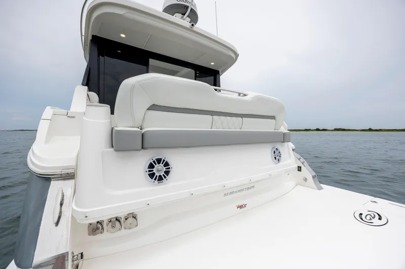 Slide: The Image of 2022 Regal 36 Grande Coupe yacht rear view on calm water. - 13