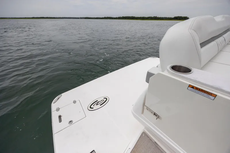 Slide: The Image of 2022 Regal 36 Grande Coupe boat deck overlooking calm waters. - 14