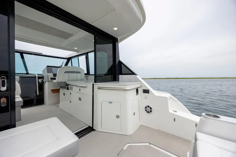Slide: The Image of 2022 Regal 36 Grande Coupe interior with open deck and water view. - 19