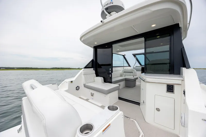 Slide: The Image of 2022 Regal 36 Grande Coupe luxury yacht interior with open seating area. - 21