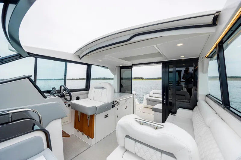 Slide: The Image of Interior view of 2022 Regal 36 Grande Coupe yacht with luxurious seating and helm. - 22