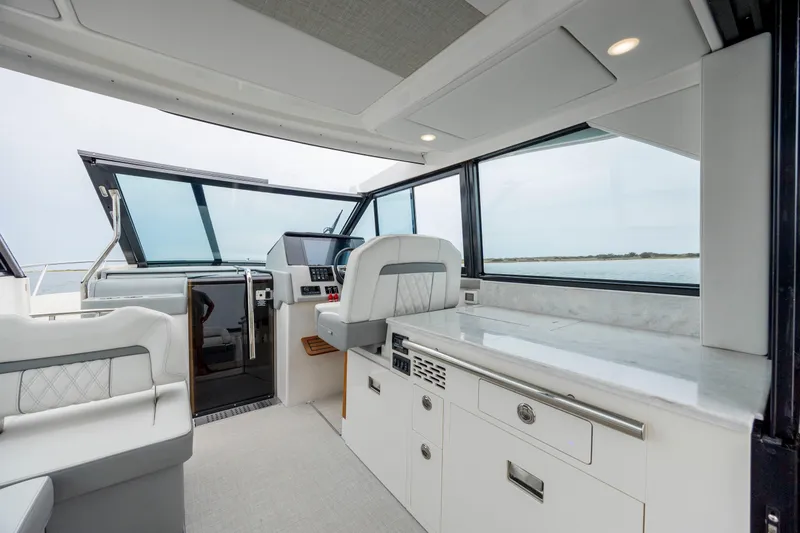 Slide: The Image of Interior of 2022 Regal 36 Grande Coupe yacht with modern helm and seating. - 24