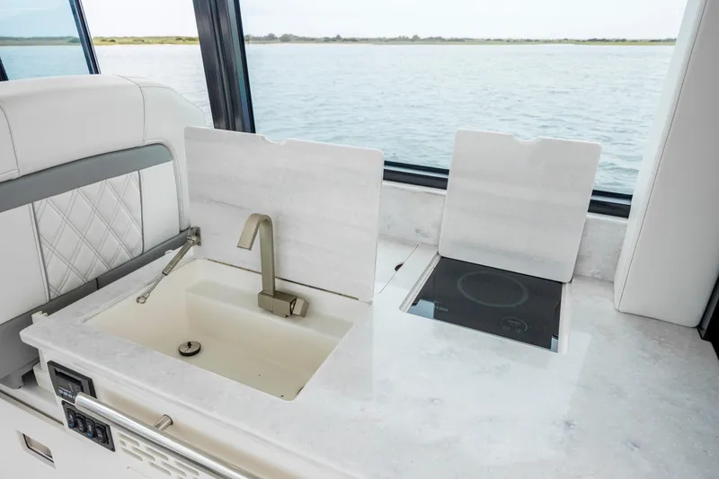 Slide: The Image of Luxury yacht kitchen with sink and stove, 2022 Regal 36 Grande Coupe. - 26