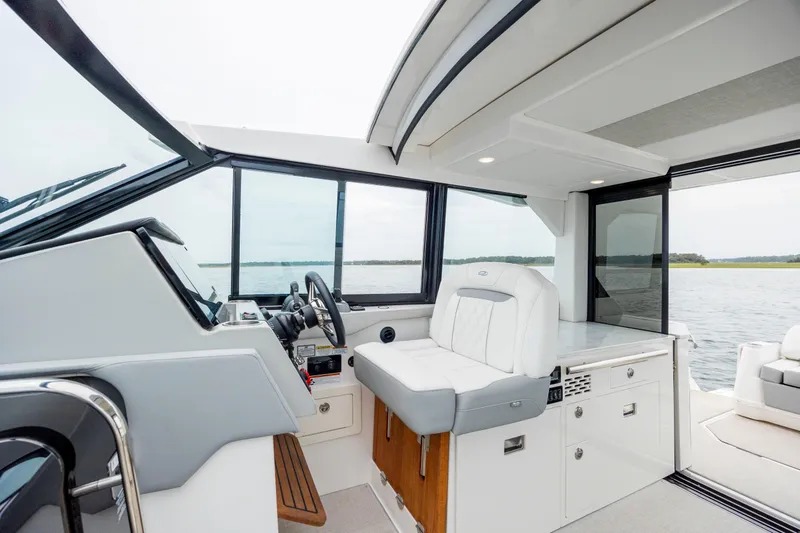 Slide: The Image of Interior of 2022 Regal 36 Grande Coupe yacht with helm and seating area. - 27