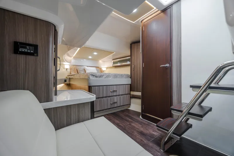 Slide: The Image of Luxurious interior of 2022 Regal 36 Grande Coupe yacht with modern furnishings and cozy bed. - 35