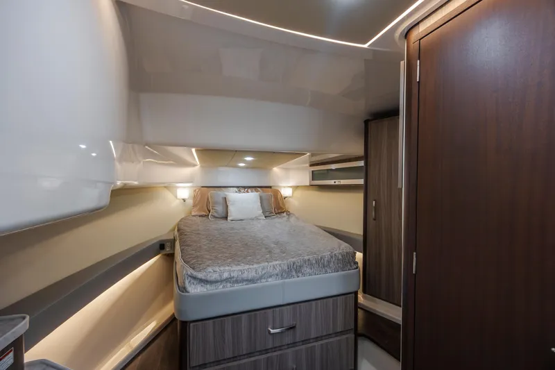 Slide: The Image of 2022 Regal 36 Grande Coupe interior cabin with bed and modern wood finishes. - 37