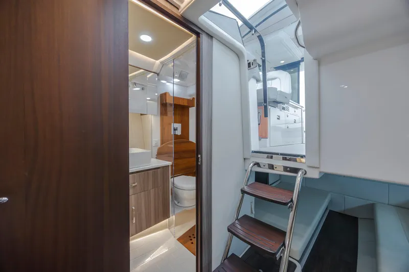 Slide: The Image of Interior of 2022 Regal 36 Grande Coupe yacht, featuring a modern bathroom and ladder access. - 39
