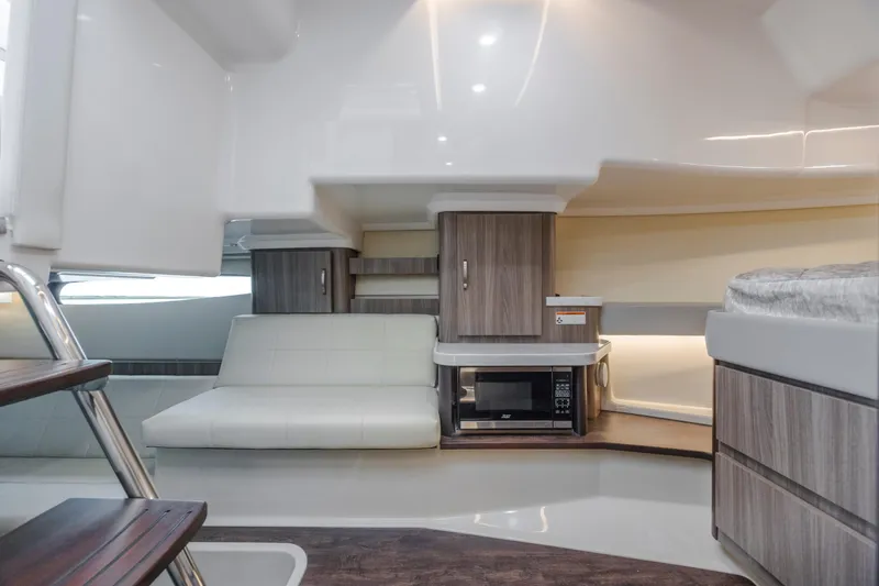 Slide: The Image of Interior of 2022 Regal 36 Grande Coupe with sofa, microwave, and modern cabinetry. - 40