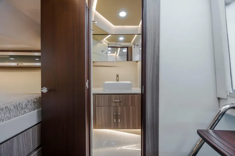 Slide: The Image of Interior of 2022 Regal 36 Grande Coupe bathroom with modern sink and wood accents. - 45