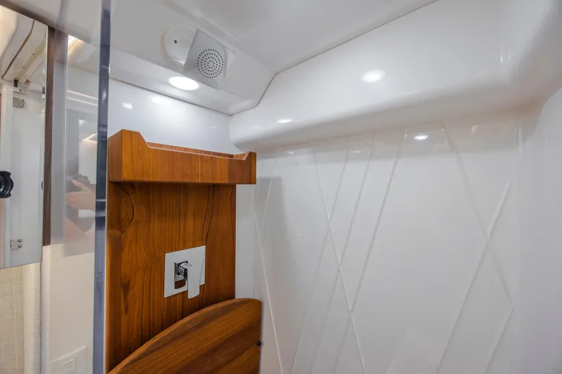 Slide: The Image of Interior of 2022 Regal 36 Grande Coupe, featuring modern wood and white paneling. - 49