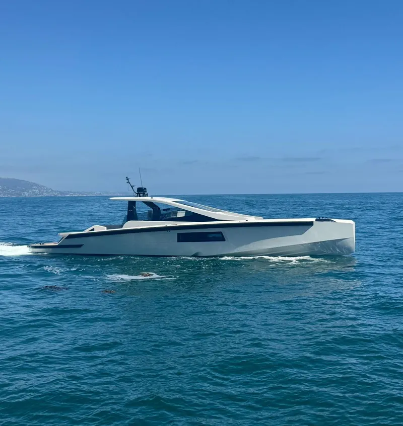 Slide: The Image of 2025 Maori 54ft XL yacht cruising on open sea under clear blue sky. - 1