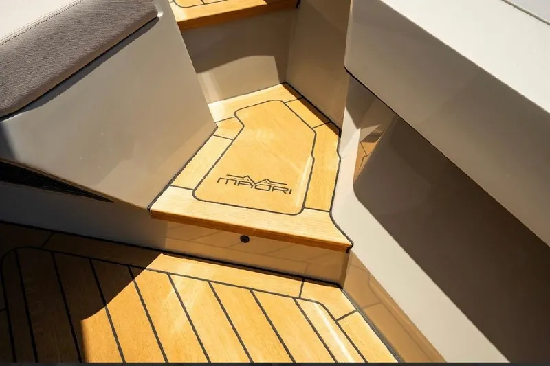 Slide: The Image of Luxury yacht interior with wooden steps, featuring Maori 54ft XL logo, 2025 model. - 14