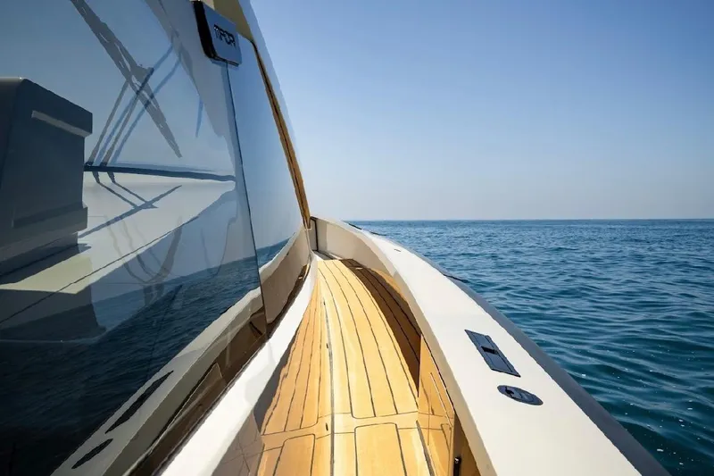 Slide: The Image of 2025 Maori 54ft XL yacht on open sea, showcasing sleek design and wooden deck. - 18